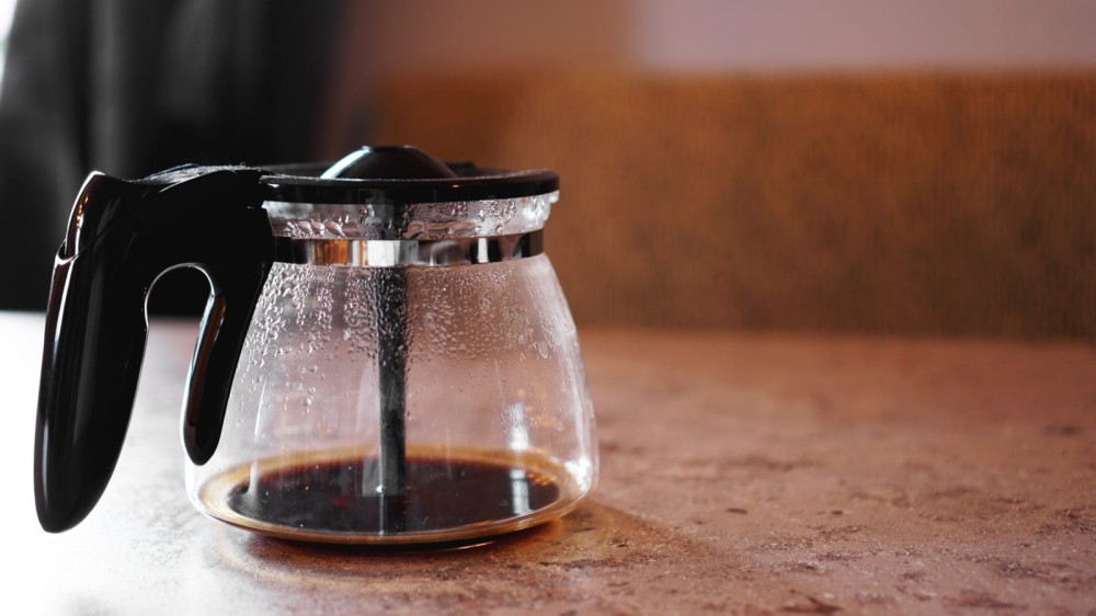 The bottom of the coffee pot placed on a countertop. 