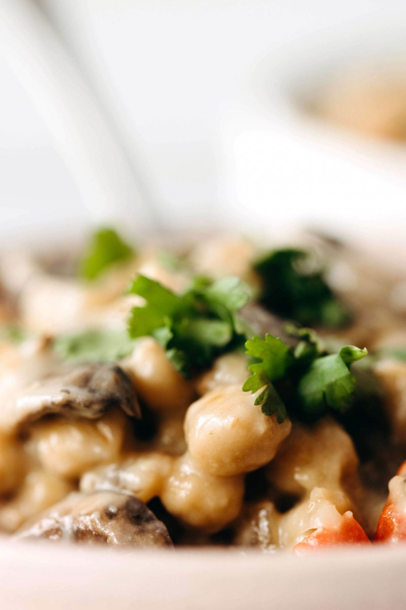 A close-up image of cooked beans and parsley.