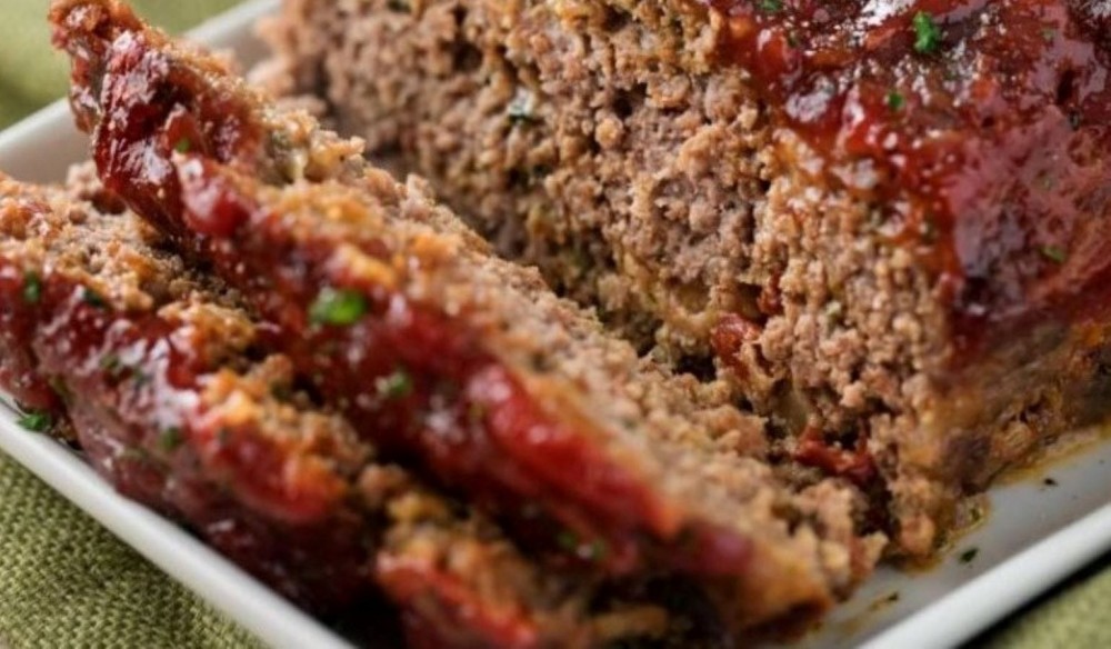 Sliced glazed chipotle meatloaf on a platter. 