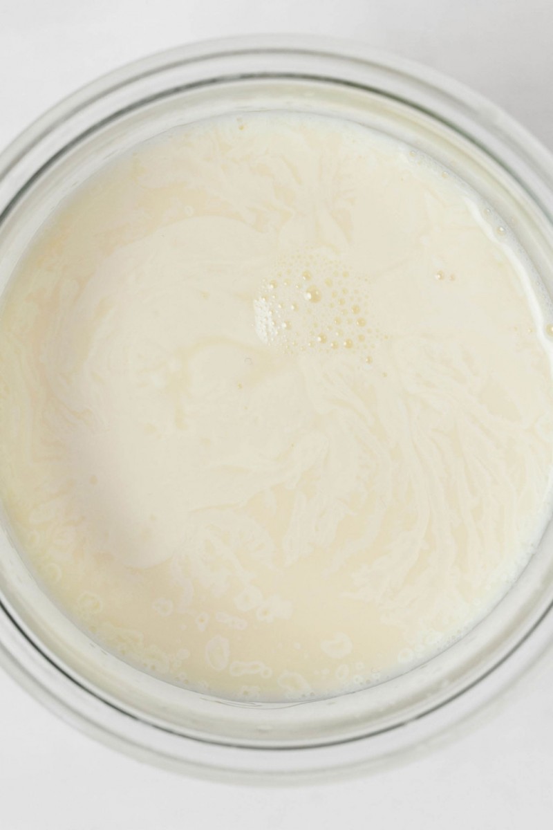 An overhead image of milk in a glass bowl.