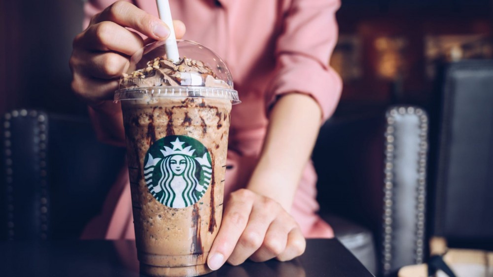 Woman drinking a Starbucks shake.