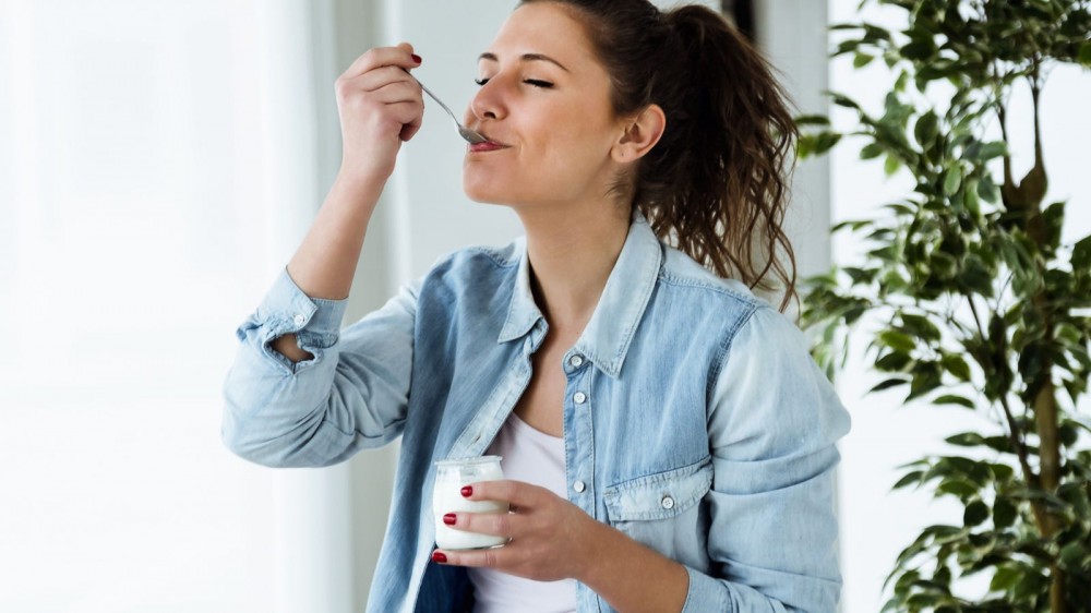 Woman eating yogurt.