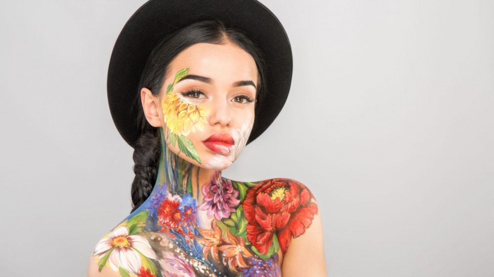 Girl wearing floral body paint.