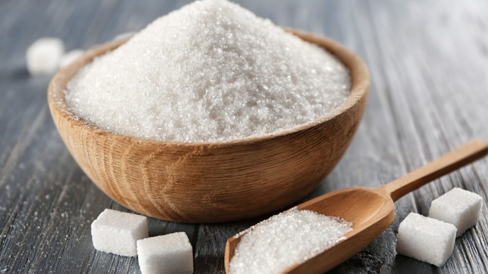 A brown bowl filled with white sugar.