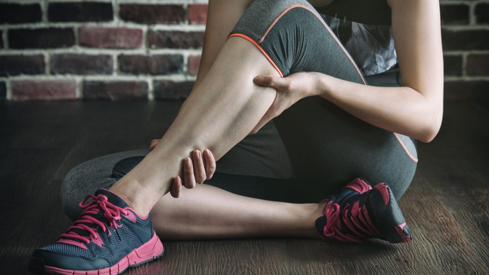 Someone massaging her muscles after an intense workout.